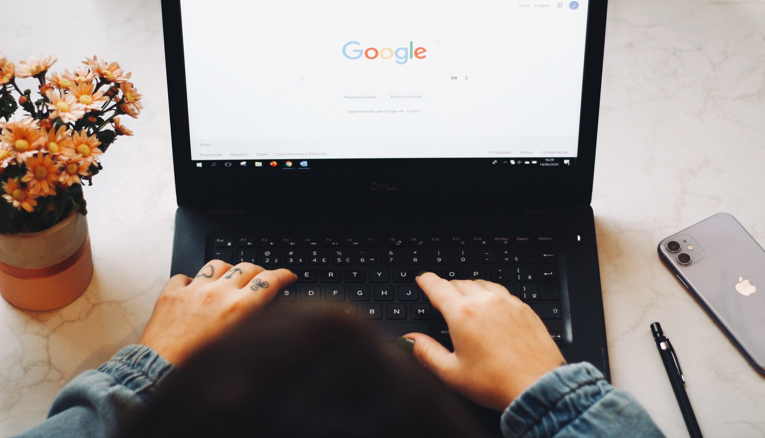 Close up of person using Google Chrome on old, black laptop