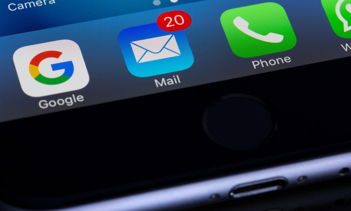 Close up of smartphone with email application showing 20 unread emails
