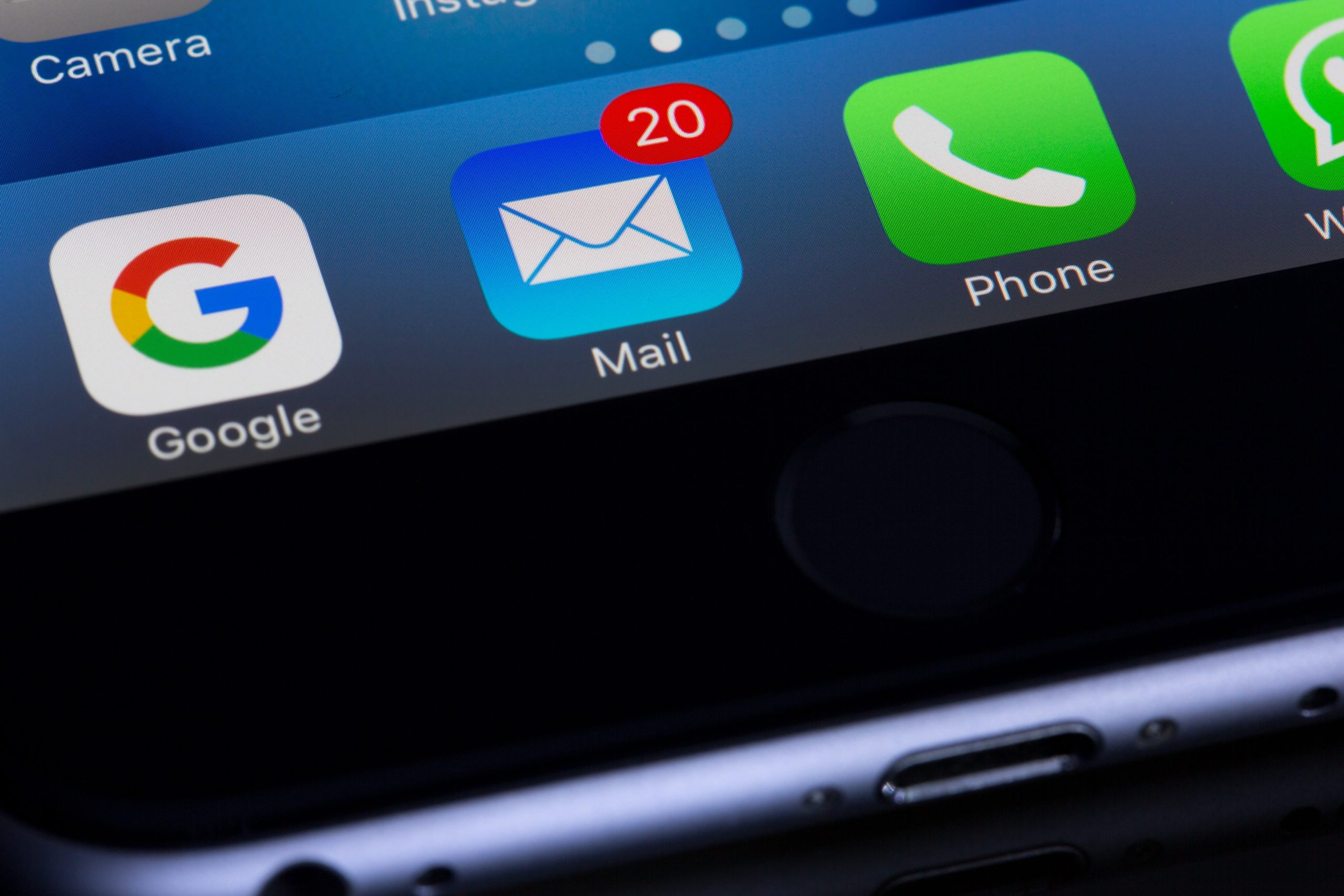 Close up of smartphone with email application showing 20 unread emails